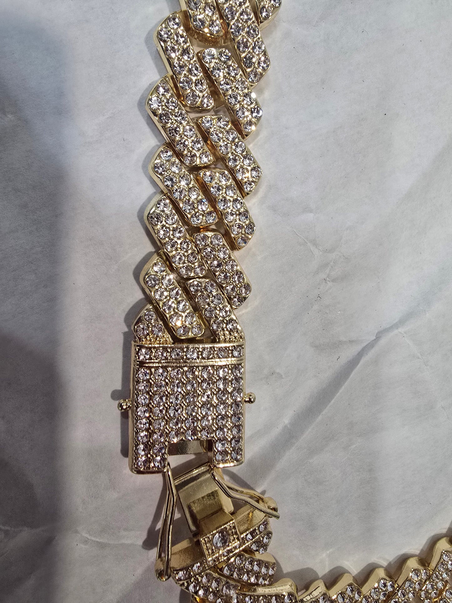 20mm "Iced Out" Cuban Link Chain: A bold 18-inch necklace featuring gold over copper and VVS CZ stones