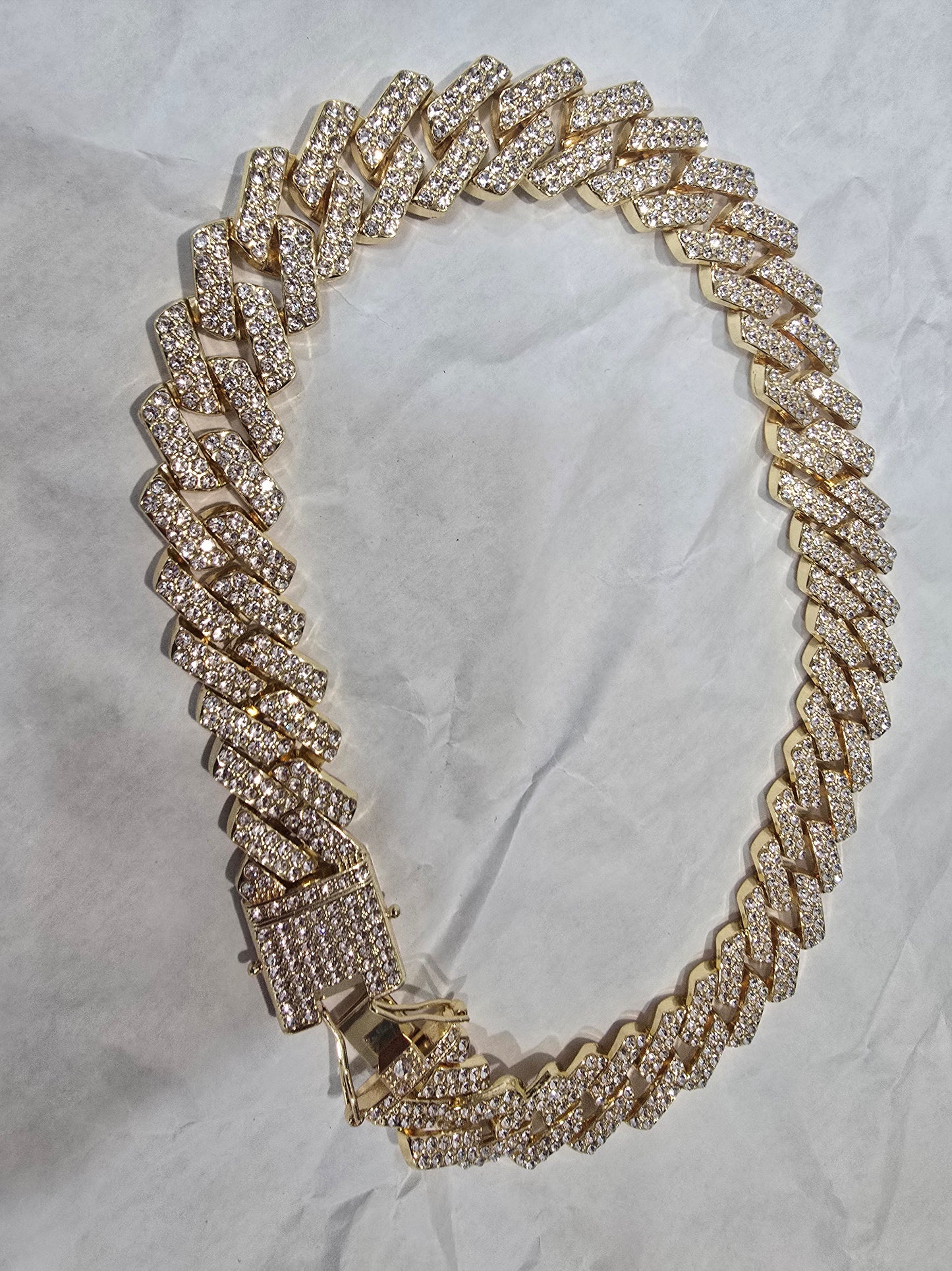 20mm "Iced Out" Cuban Link Chain: A bold 18-inch necklace featuring gold over copper and VVS CZ stones
