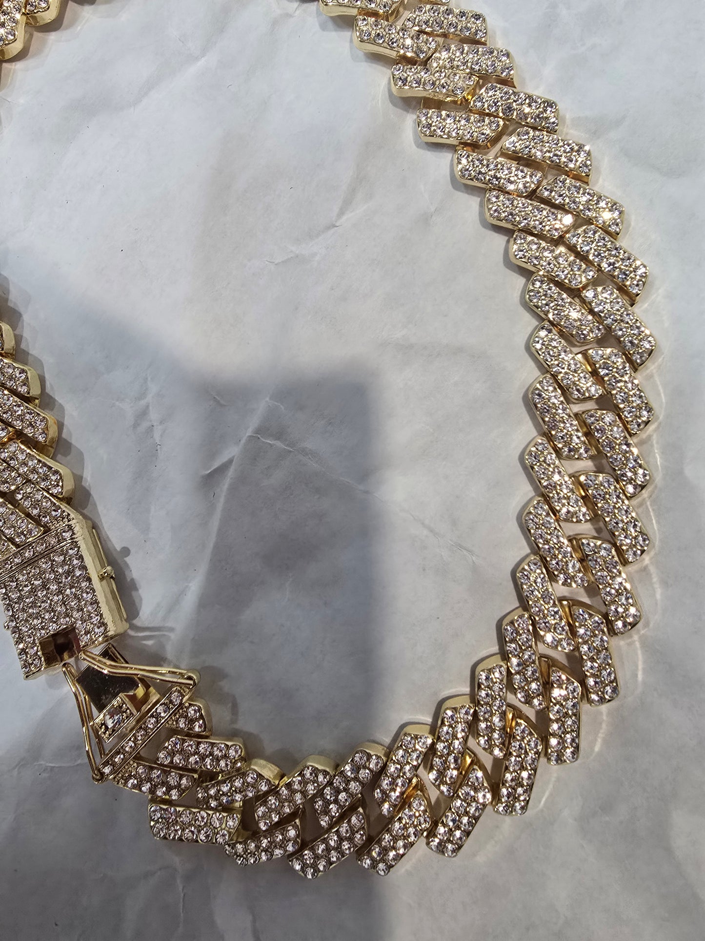 20mm "Iced Out" Cuban Link Chain: A bold 18-inch necklace featuring gold over copper and VVS CZ stones