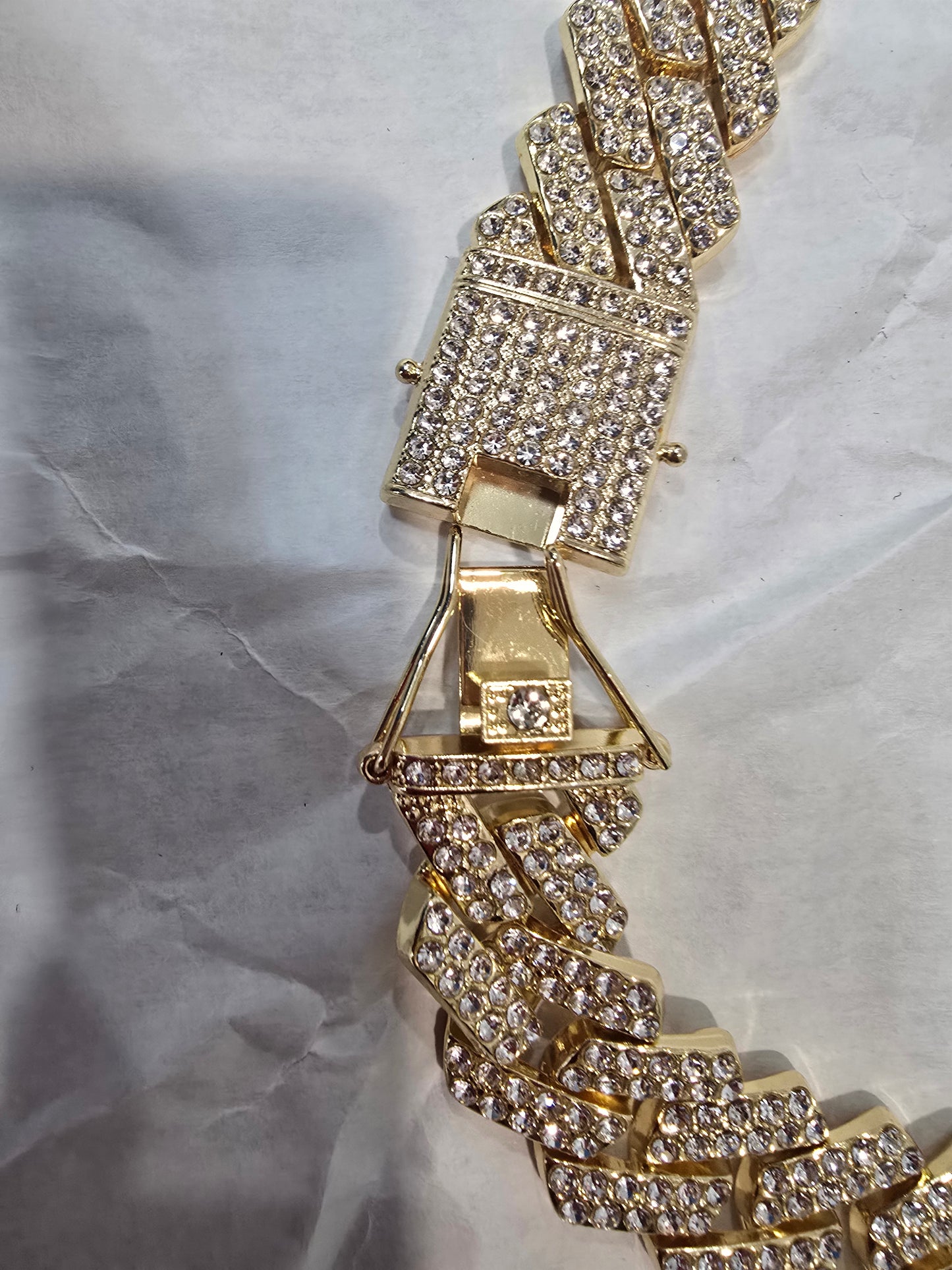 20mm "Iced Out" Cuban Link Chain: A bold 18-inch necklace featuring gold over copper and VVS CZ stones