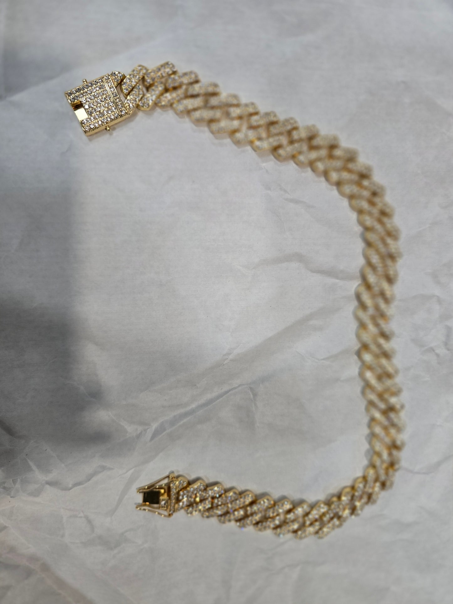 20mm "Iced Out" Cuban Link Chain: A bold 18-inch necklace featuring gold over copper and VVS CZ stones